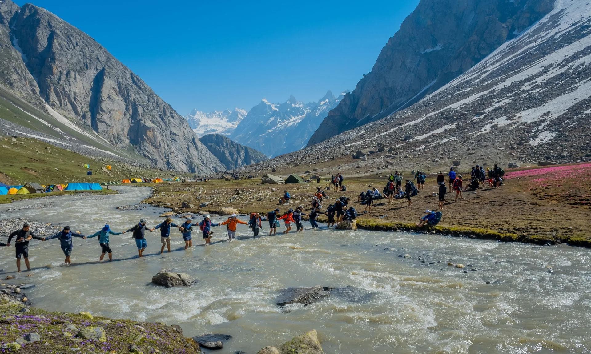 Trekkers crossing the snow-filled Hampta valley