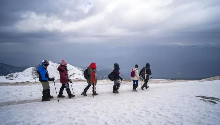 Trekkers climbing the snowy trail toward Juda Ka Talab